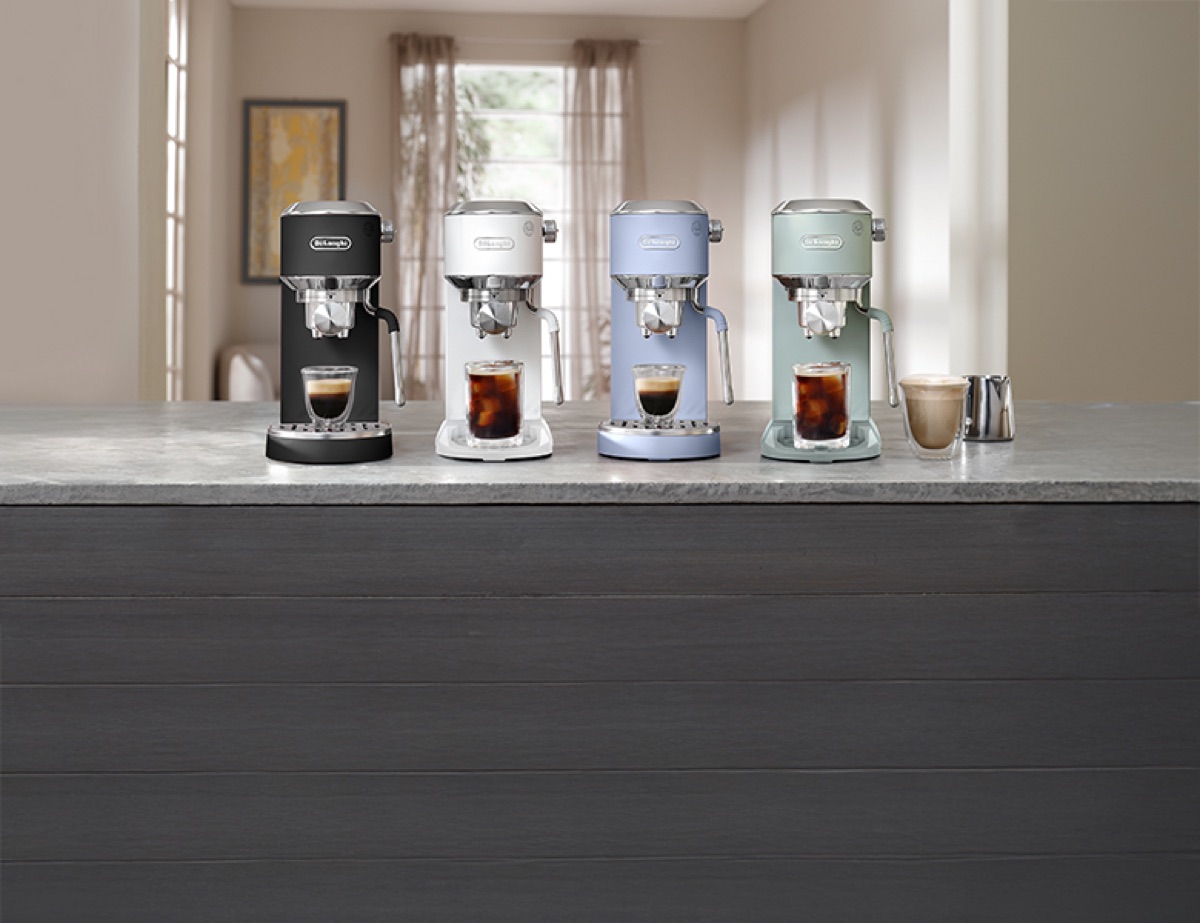 The De'Longhi Dedica range in four colours on a kitchen bench